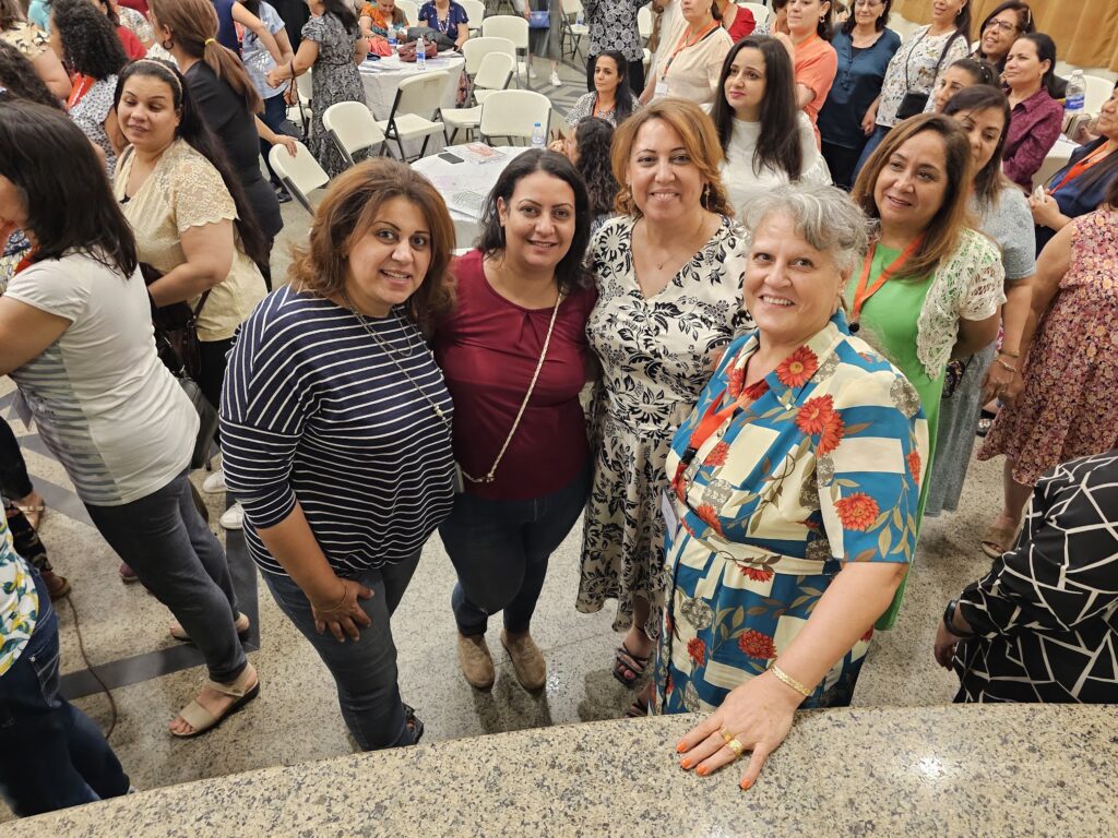 Women at the confrence connect with one another.